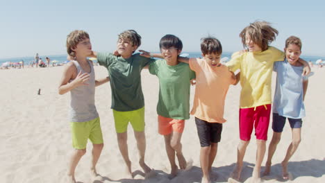 Boys-hugging-each-others-neck-and-jumping-for-joy-on-beach